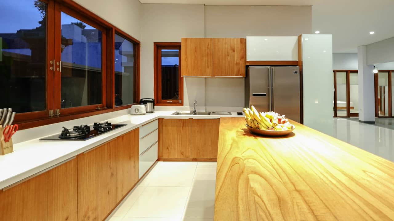 Spacious kitchen with modern appliances, cooking utensils, and dining ware