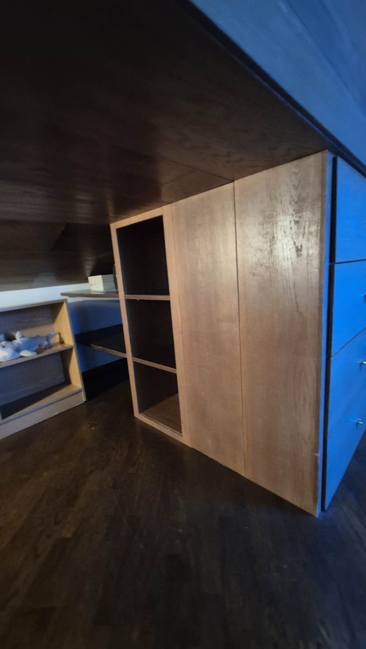 Dormitorio con armario empotrado de madera y cama junto a la ventana