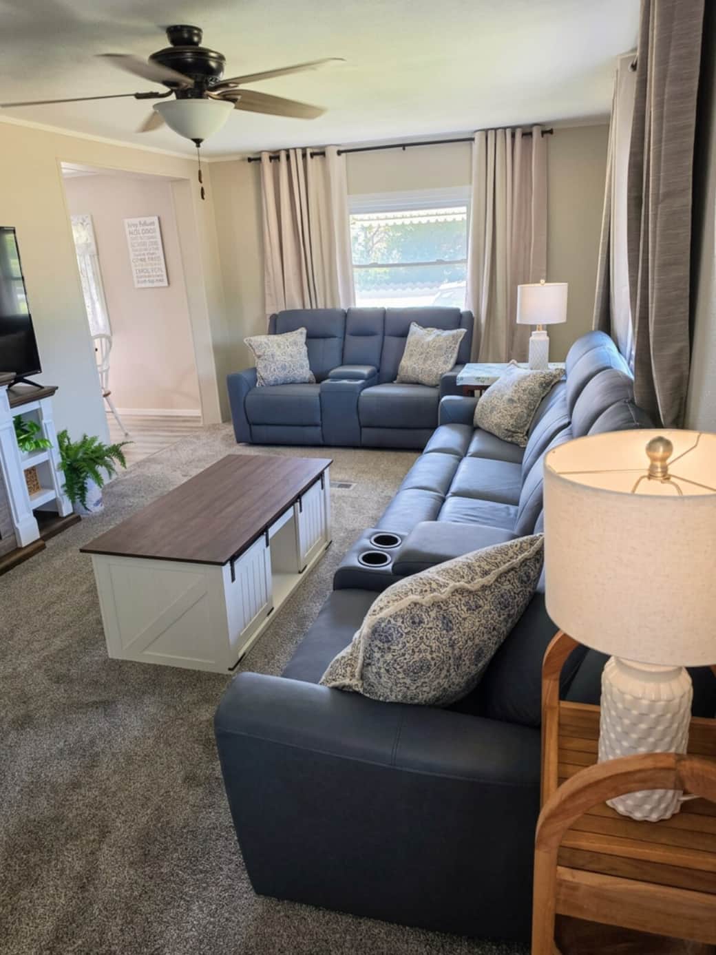 Large couch and loveseat with 4 recliners and lift up table.