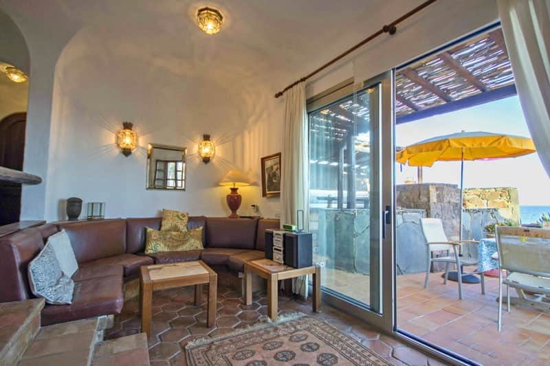 Rocadelmar1 living room leather sofa set and glass doors terrace