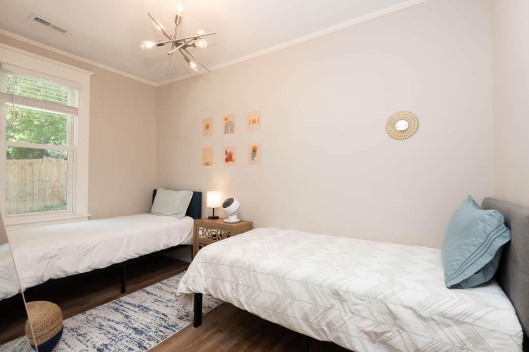 3rd bedroom with two twin beds, a mirror, and a closet. 