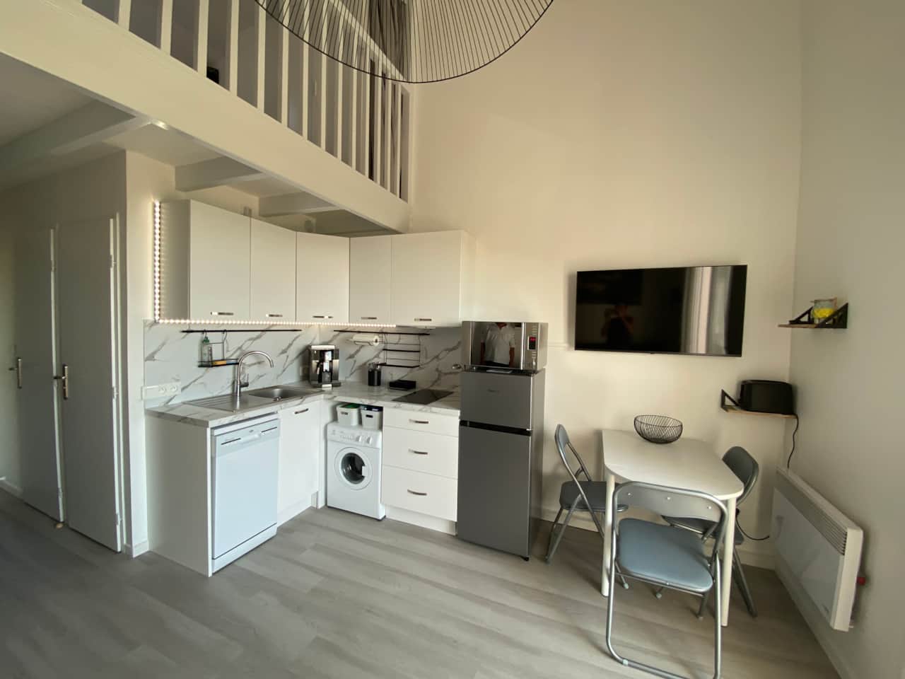 Fully equipped kitchen and dining area with table and four chairs