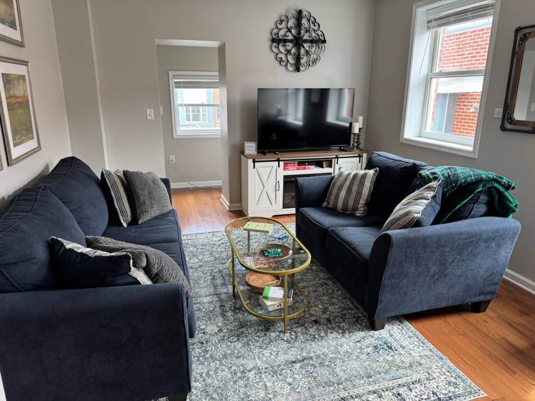 Cozy living room with full sized couch, Love seat, TV and heater insert in cabinet. Cozy living room with full sized couch, Love seat, TV and heater insert in cabinet.