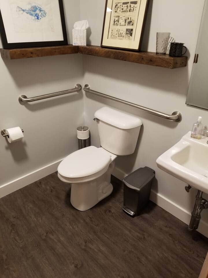 Bathroom is fully accessible and equipped with access railings.