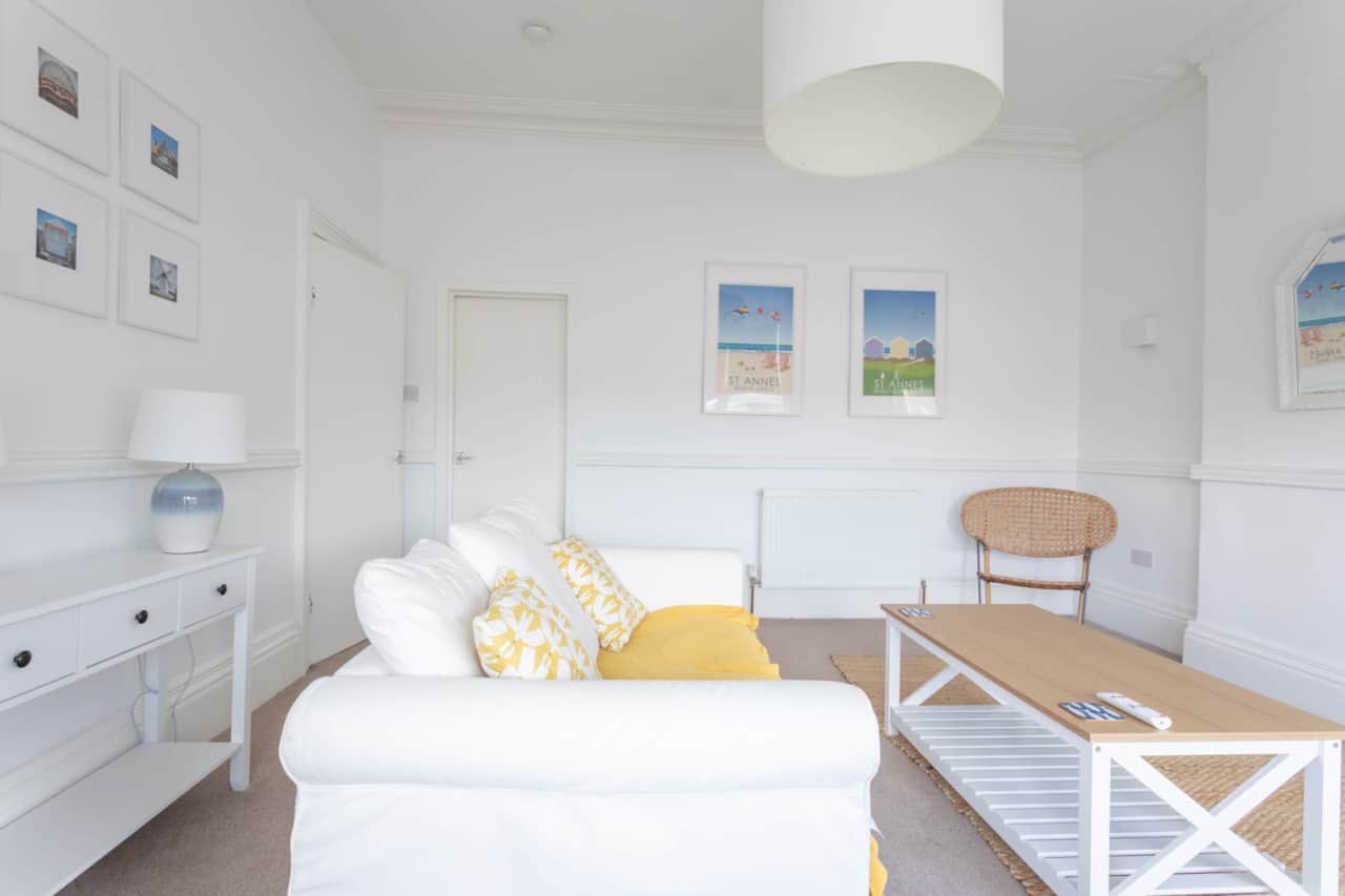 A spacious, bright living room. With huge bay windows, a dining area for two and a smart TV.