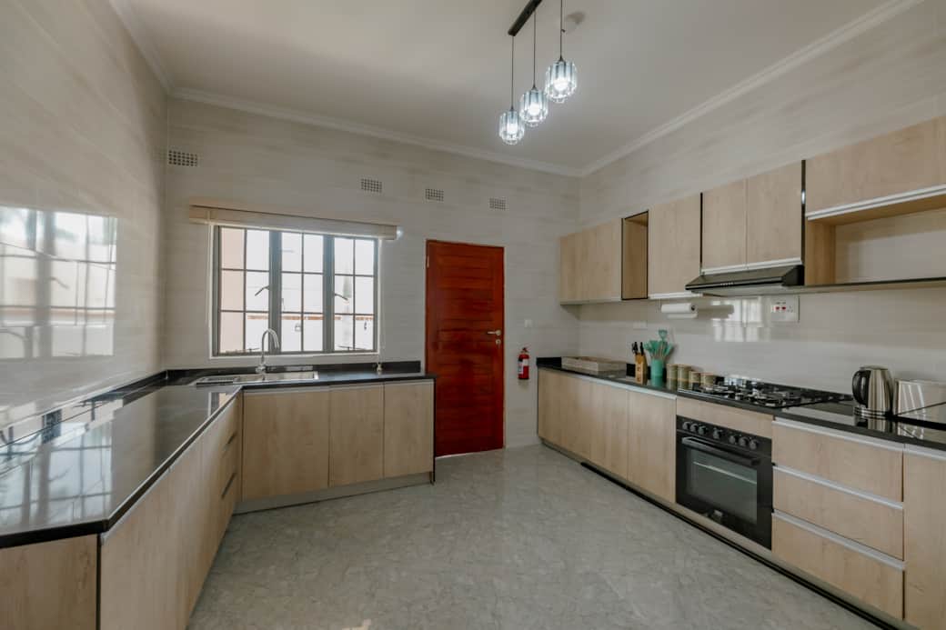 Fully equipped kitchen with oven, stove, and ample counter space