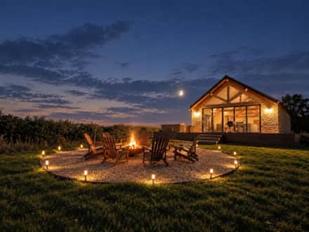 Firepit and outdoor seating at The Cotswold Barn in the early evening