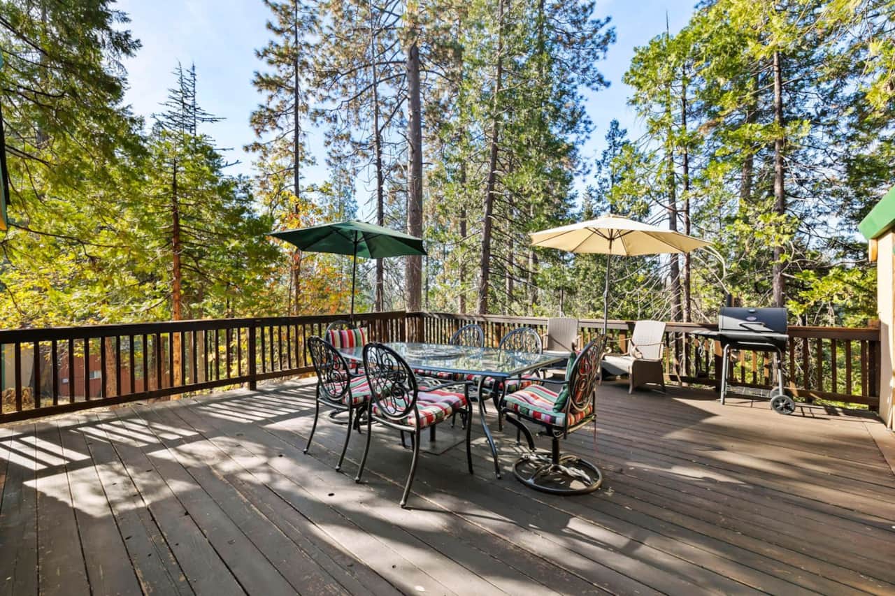 Mountain magic meets ultimate relaxation! Savor BBQ delights on this expansive deck while soaking in the panoramic mountain vistas. #mountaingetaway #decklife 