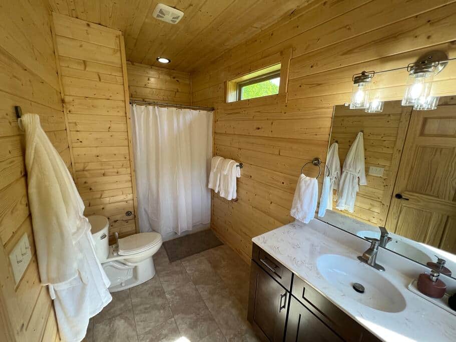 Ensuite bathroom with plush robes, large walk-in shower with toiletries, and marble vanity