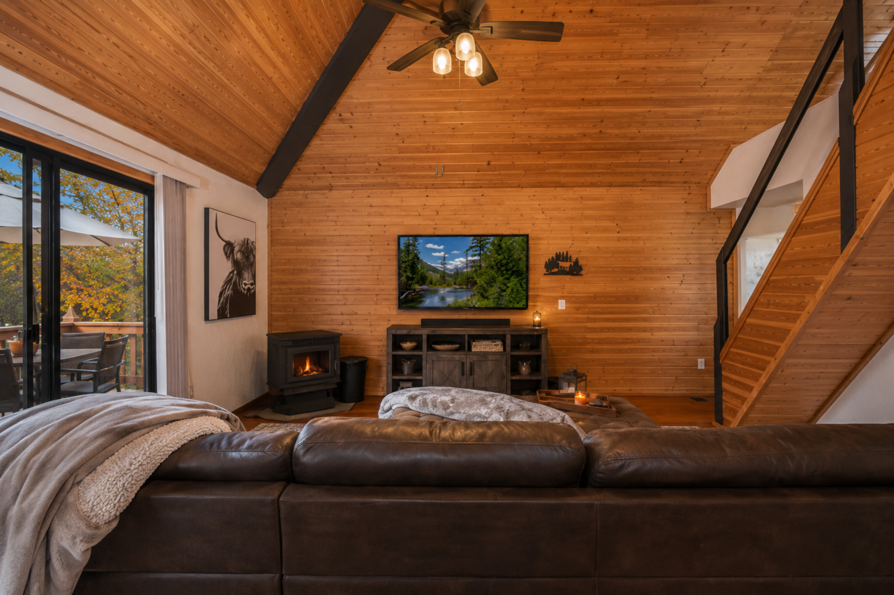 Living room entertainment area with TV in forest cabin
