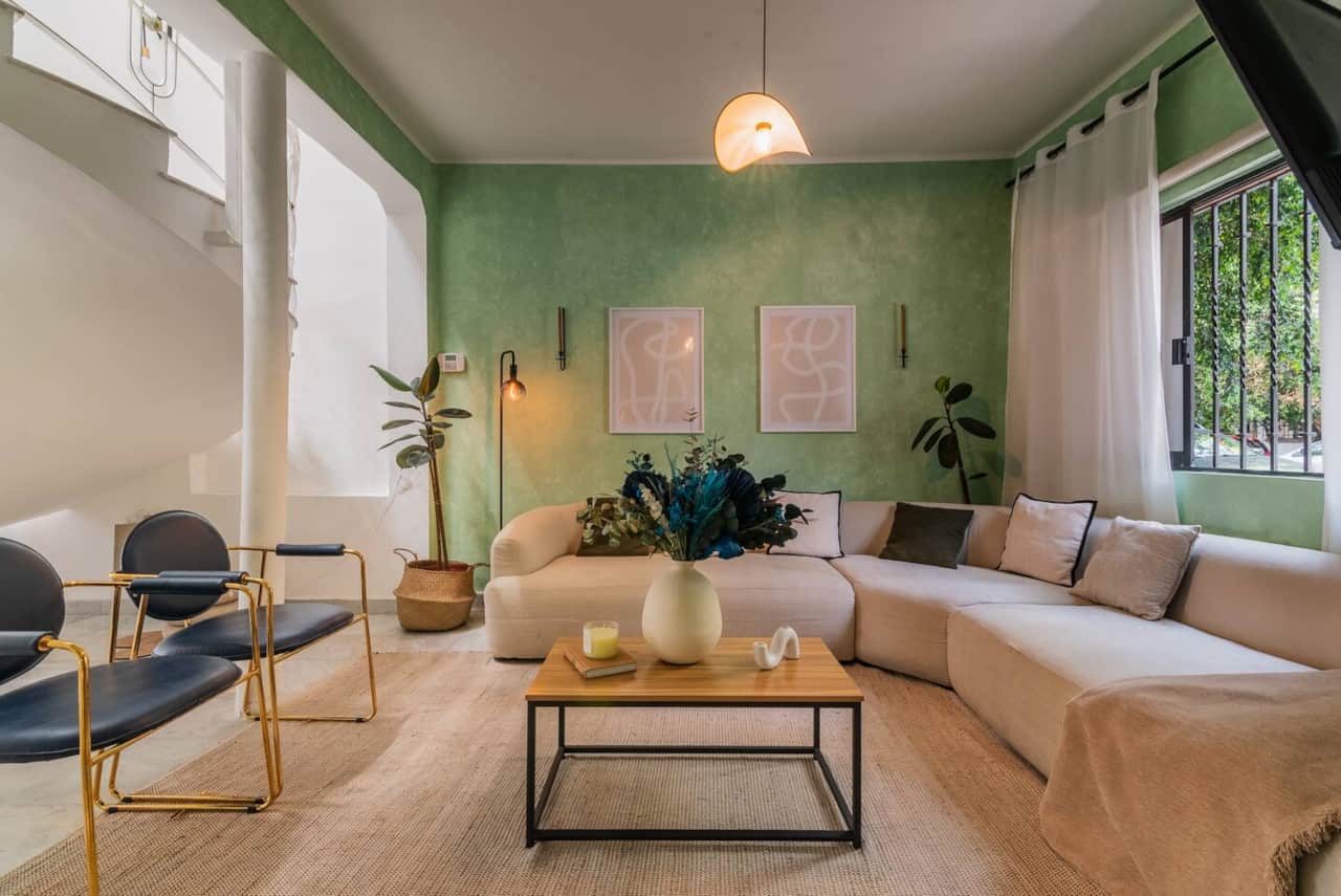 Living room with sectional sofa at Casa Atlixco villa in La Condesa