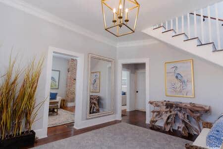 The entryway seamlessly combines coastal modern decor and history. 