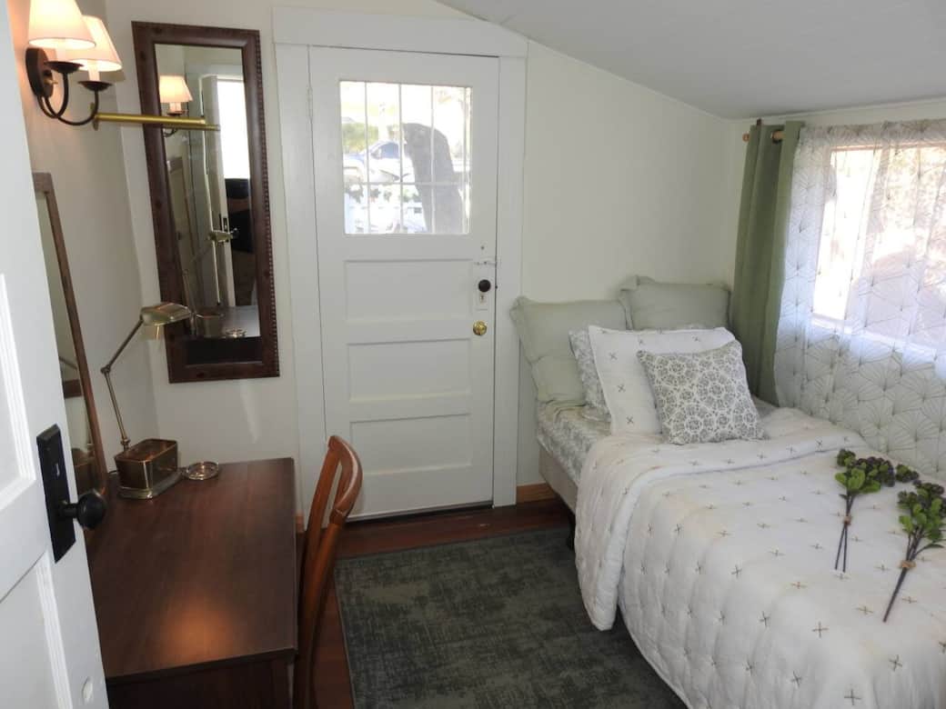 Front bedroom with twin bed, private acess and desk.