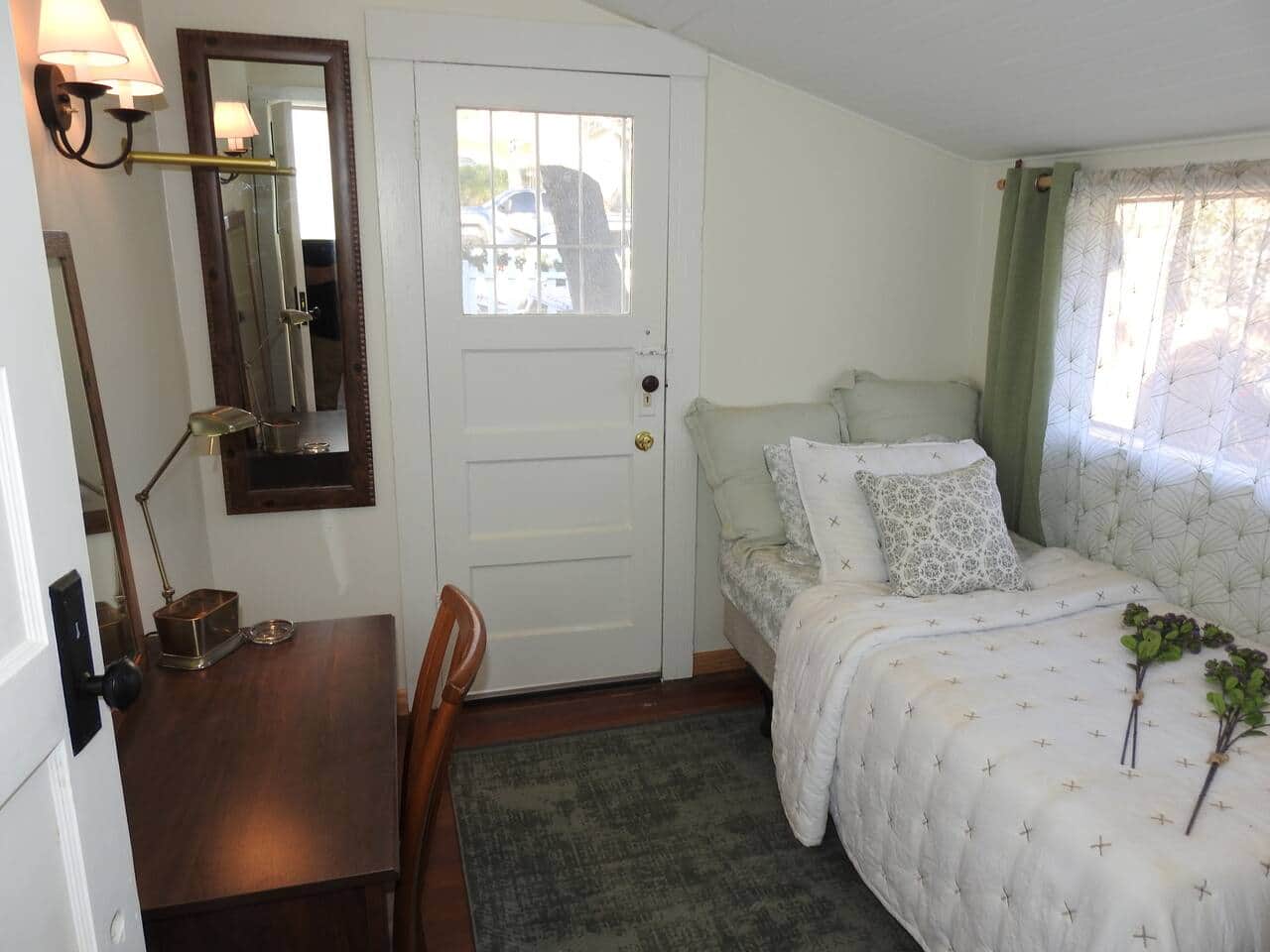 Front bedroom with twin bed, private acess and desk.