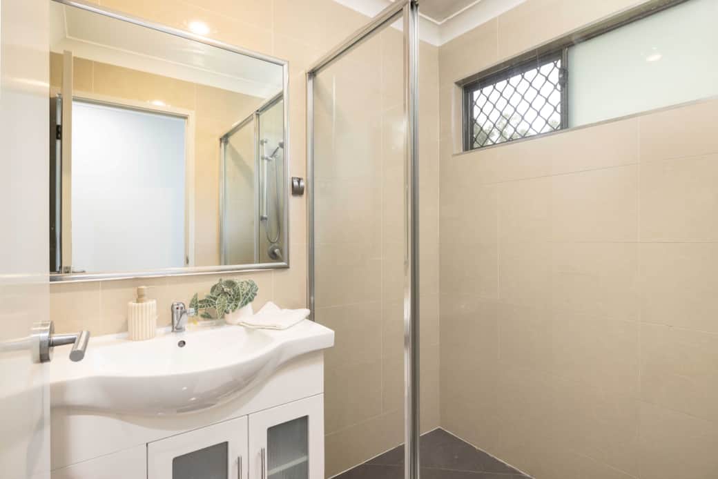 Bathroom: Stylish bathroom with walk-in shower, vanity, and clean finishes