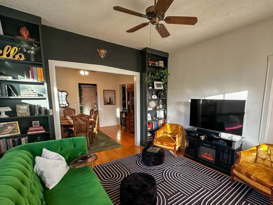 This living room has a wealth of available reading material and streaming options that you can enjoy with the ambient glow of an electric fireplace, heating optional.