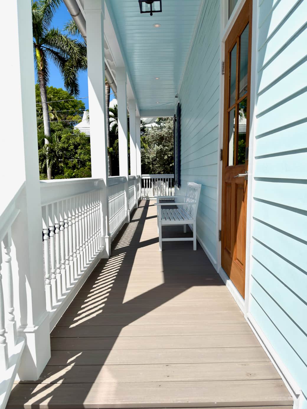 Classic Old Town Key West exterior with wraparound porches, tropical landscaping, and gated parking