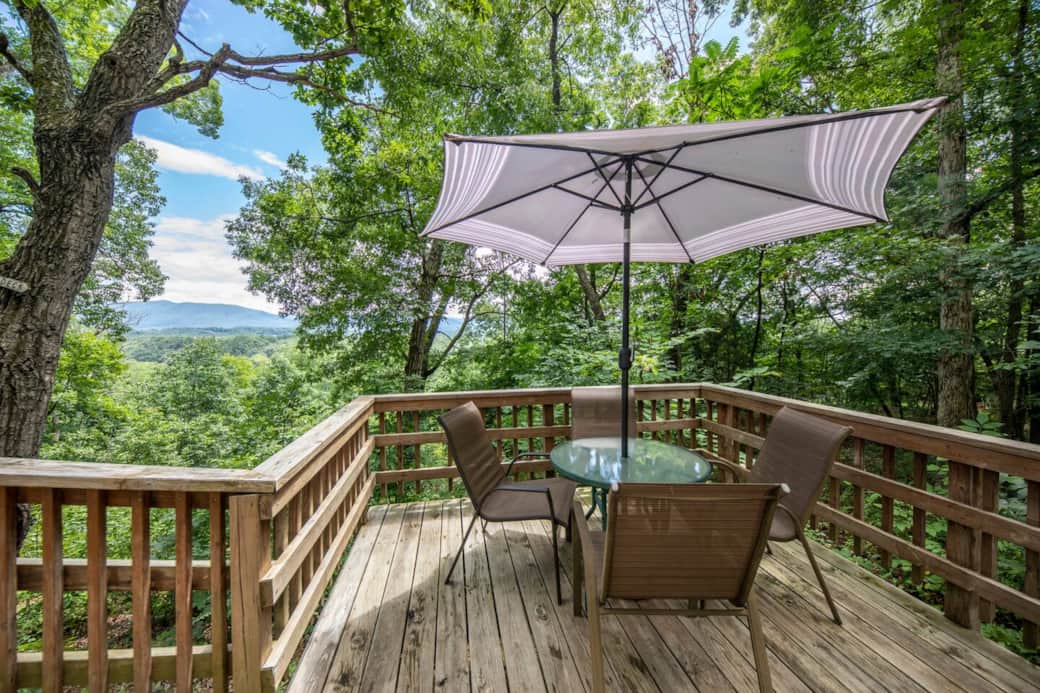 enjoy a meal outdoors on the dining deck with Blue Ridge Mountain views in the background, charcoal grill is located on this deck