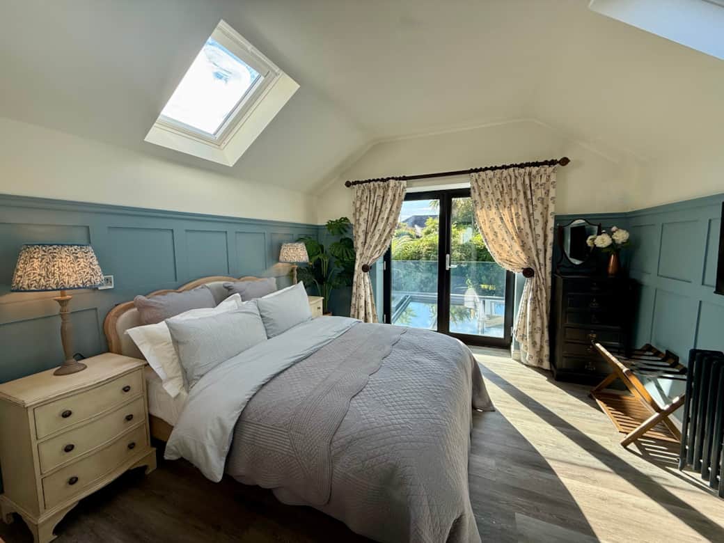 Spacious king-size bedroom with bright windows and en-suite