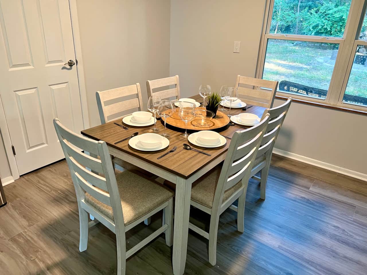 Enjoy your meal at this dining room table overlooking the backyard