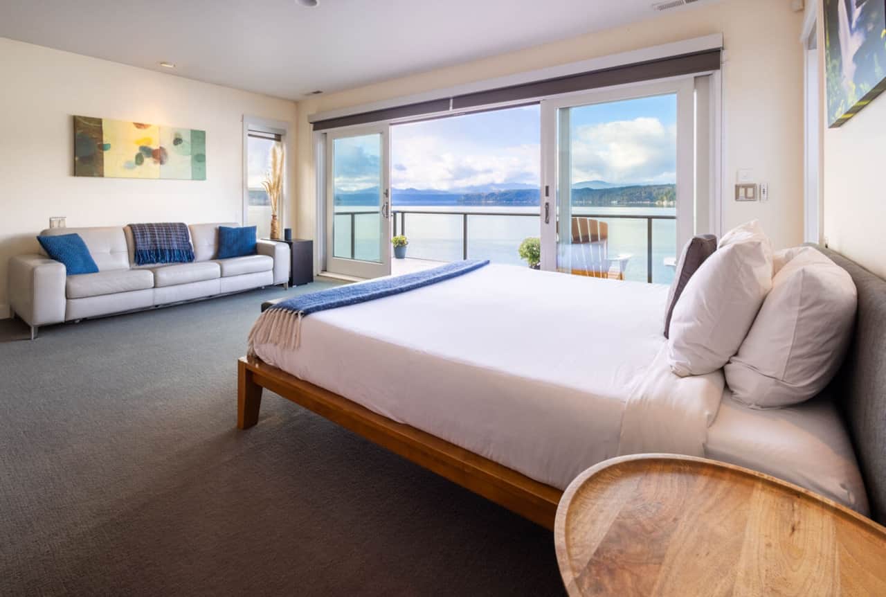 The bedroom with Tuft & Needle Cali king bed, Natuzzi sleeper sofa, and thoughtful art and decor
