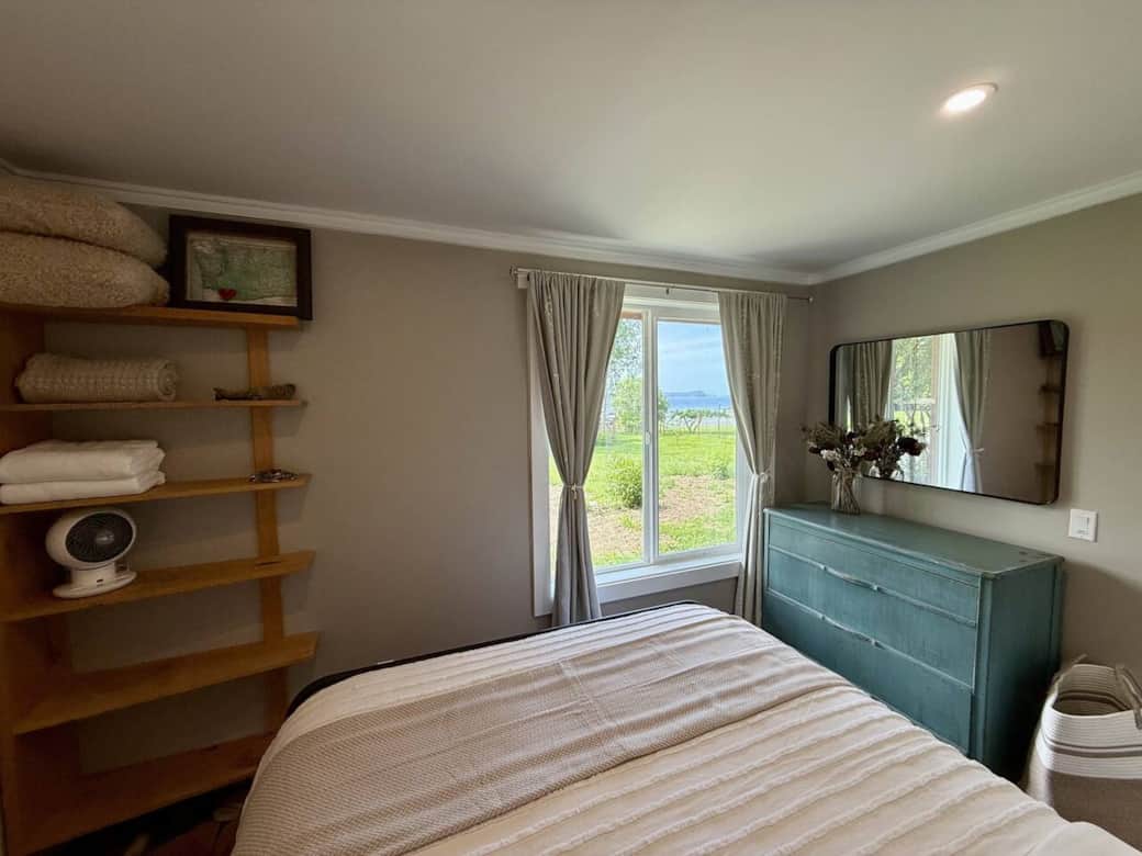 Wake up to peaceful island views from this cozy bedroom featuring a comfortable bed, dresser storage, and large window that fills the space with natural light.
Wake up to peaceful island views from this cozy bedroom featuring a comfortable bed, dresser storage, and large window that fills the space with natural light.