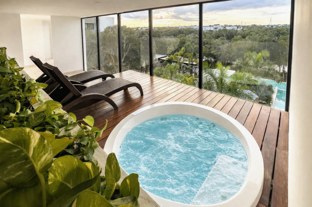 Unwind in the third-floor hot tub with loungers and lush views—perfect for sunset relaxation.!!
