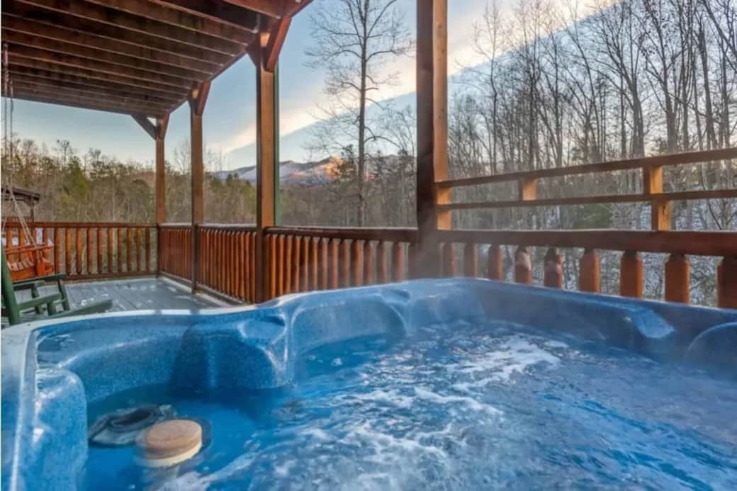 6 person hot tub located on bottom floor deck, surrounded by wooded property with lots of privacy.