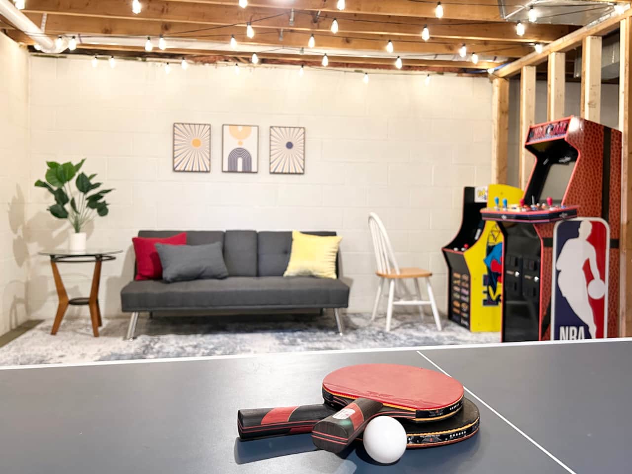 The unfinished basement doubles as an arcade/game room.