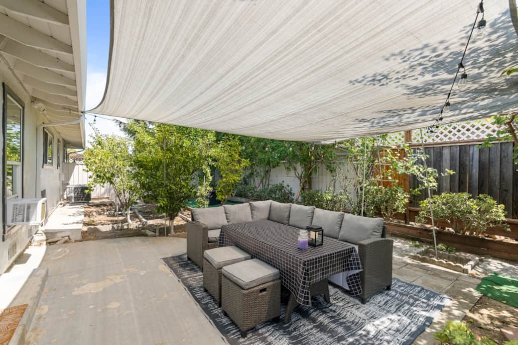 A spacious fully fenced backyard with outdoor seating, firepit and plenty of fruit trees.