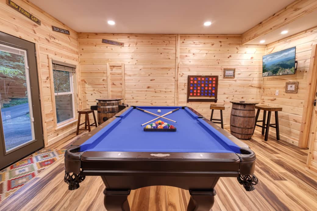 Gameroom with pool table, 43" FireTV, barrel arcade,  racing arcade, shuffleboard, & Connect Four.