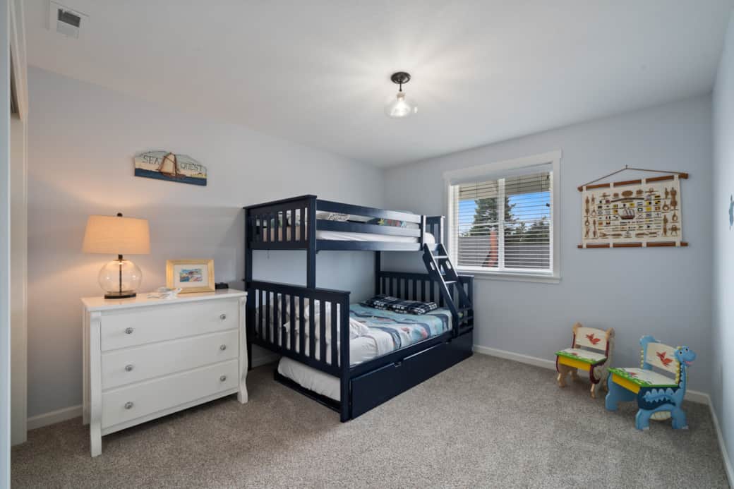 Kids and teens will love this fun bunk room with double, twin, and trundle beds for the whole crew.