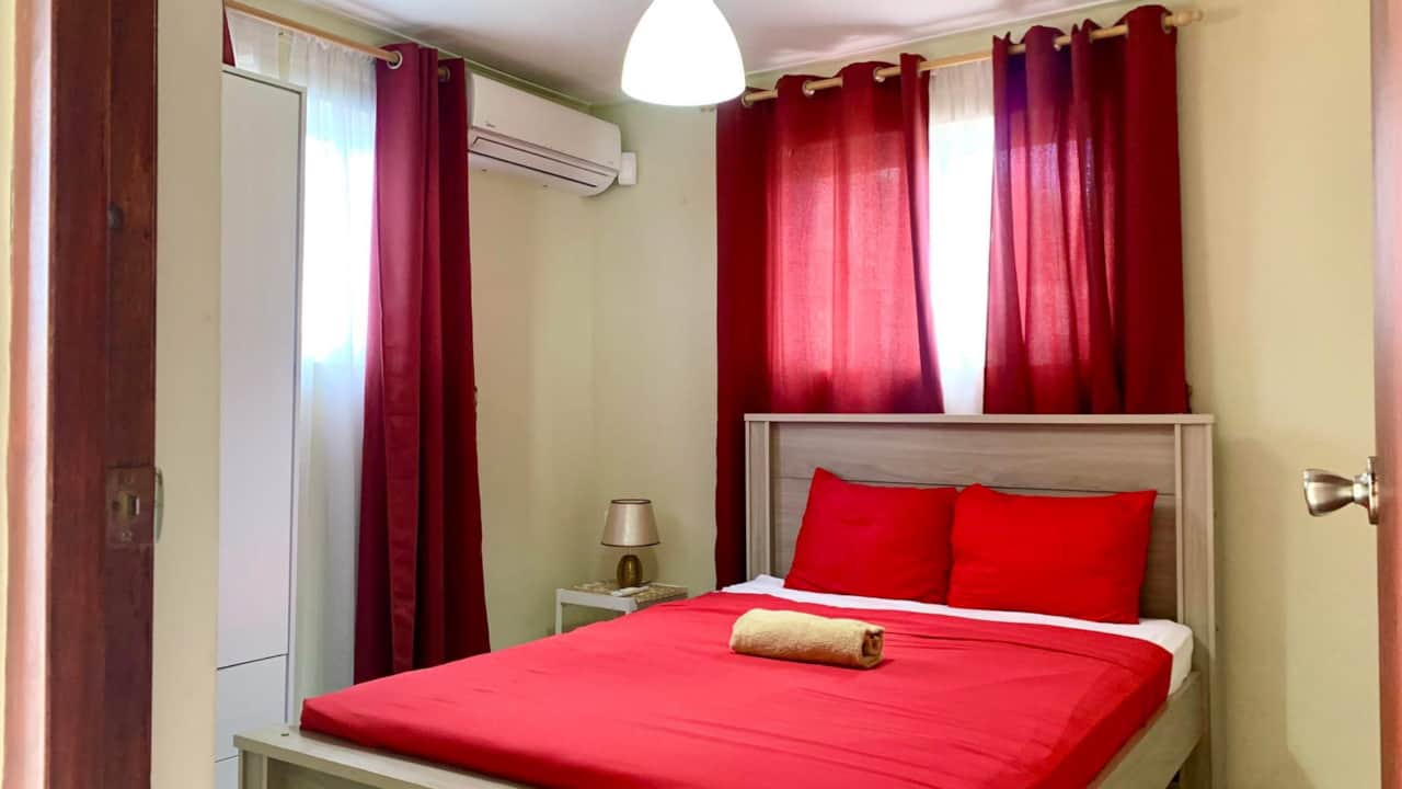 Master Bedroom: Full bed, air conditioning, linens, bath towels, reading lamps, wardrobe, & safe box