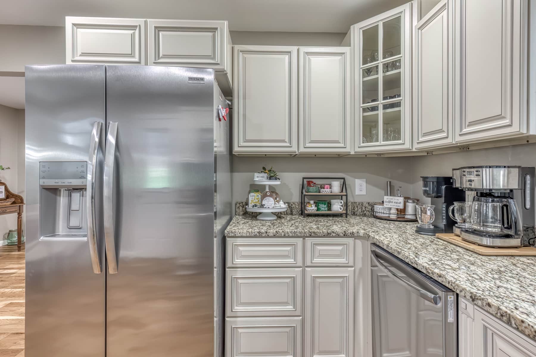Spacious open-concept kitchen with full-size refrigerator, electric range, microwave, dishwasher, and stocked cabinets for family meals.