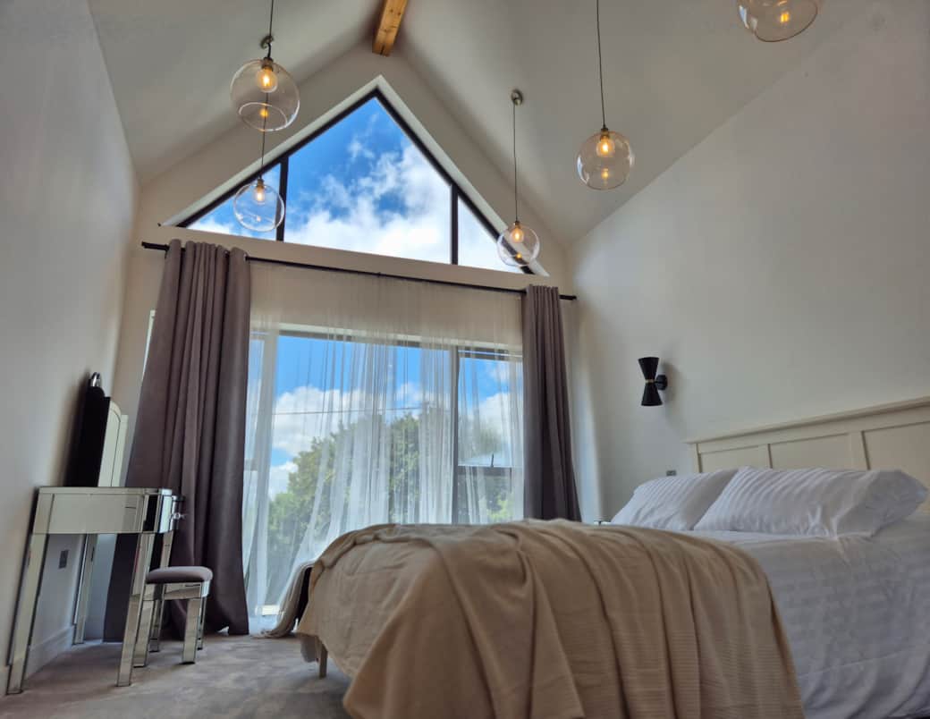 Vaulted master Bedroom with view across the Buckinghamshire countryside. 