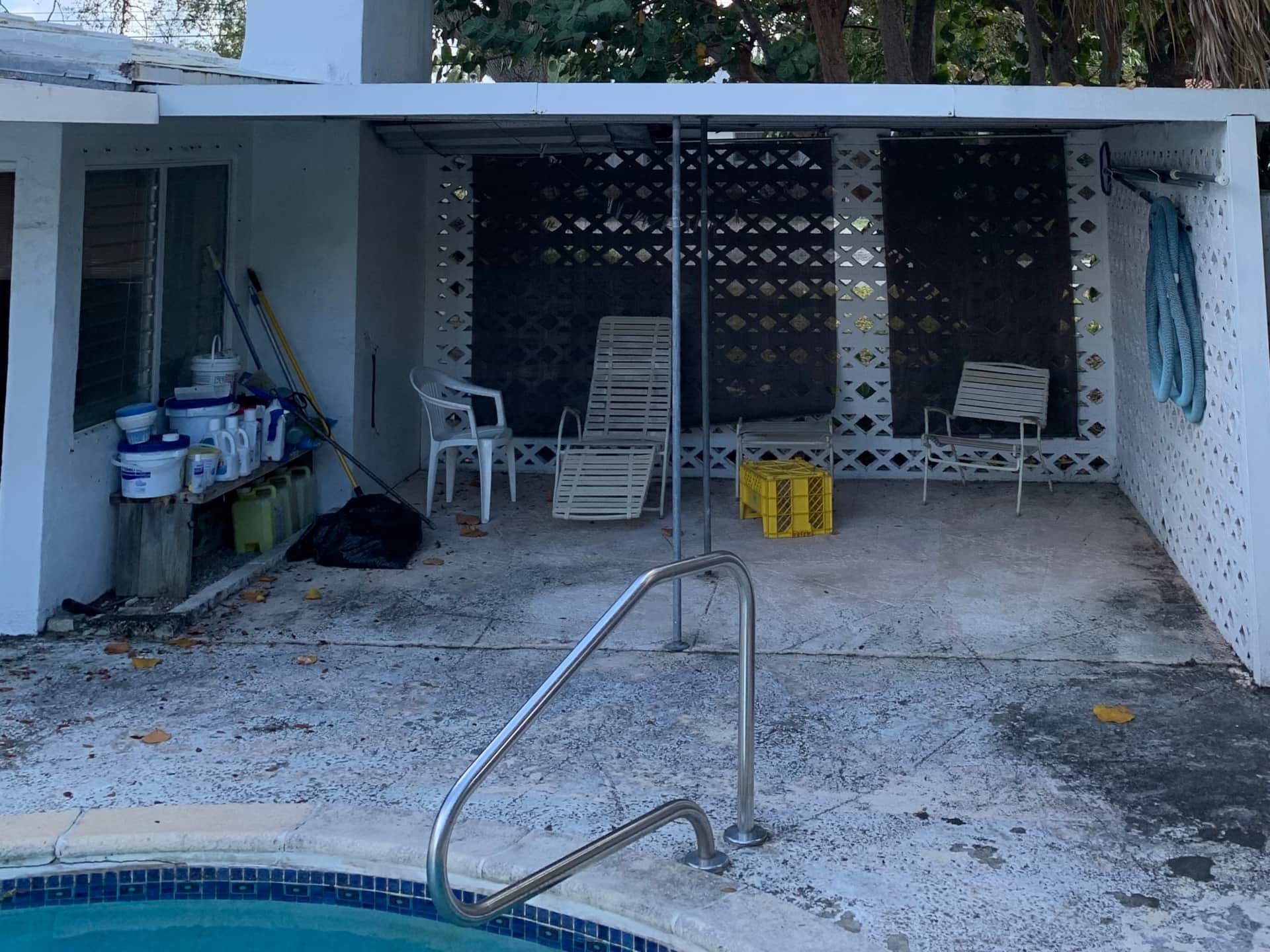 Covered patio at Casa Citron before renovation, showing an outdated outdoor space in need of design updates and modernization.