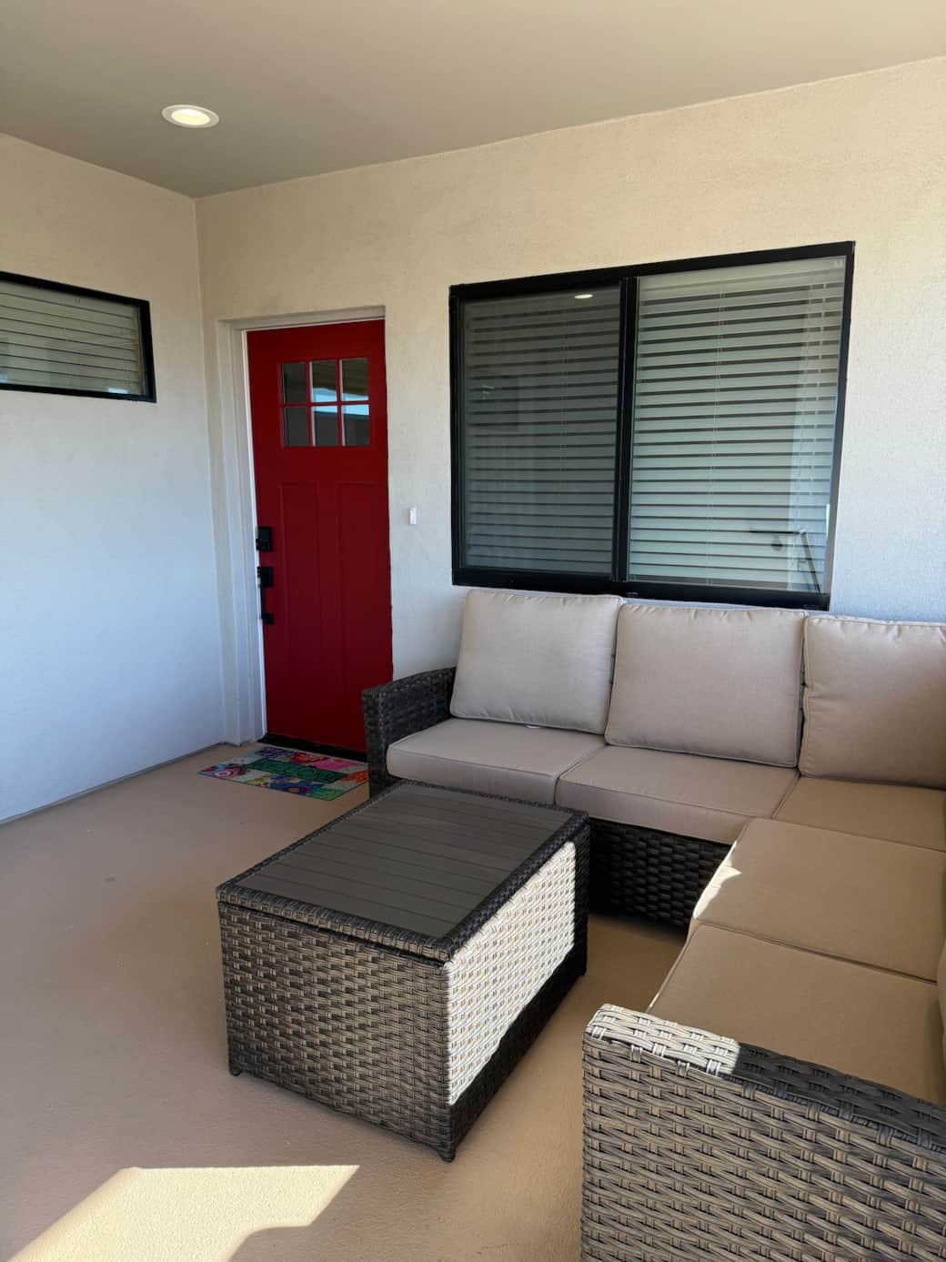 Upon entering the home this covered porch space offers an additional outdoor space to drink your morning coffee or have an evening cocktail.