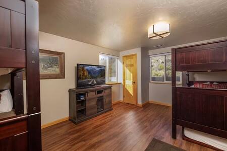 Cozy bedroom with bunk beds and wood flooring