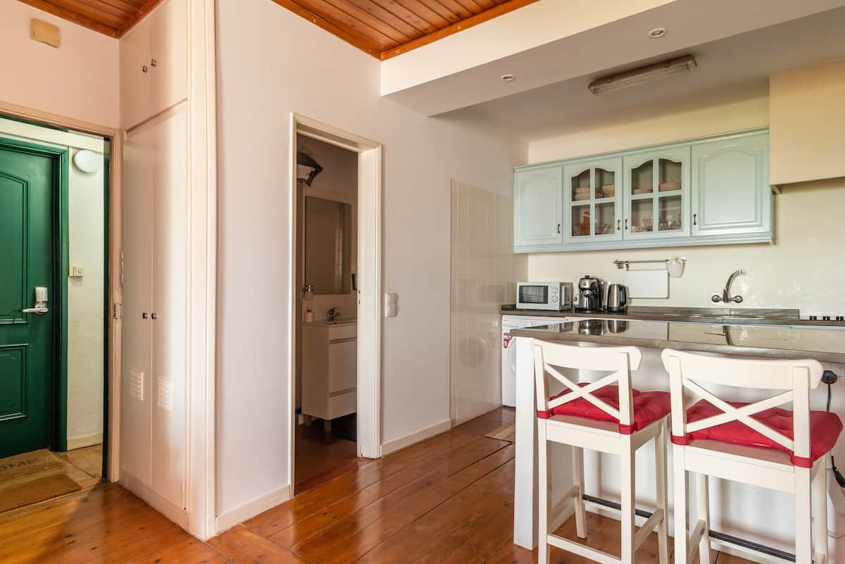 Dining area, with main door, bathroom and kitchenette in the back ground