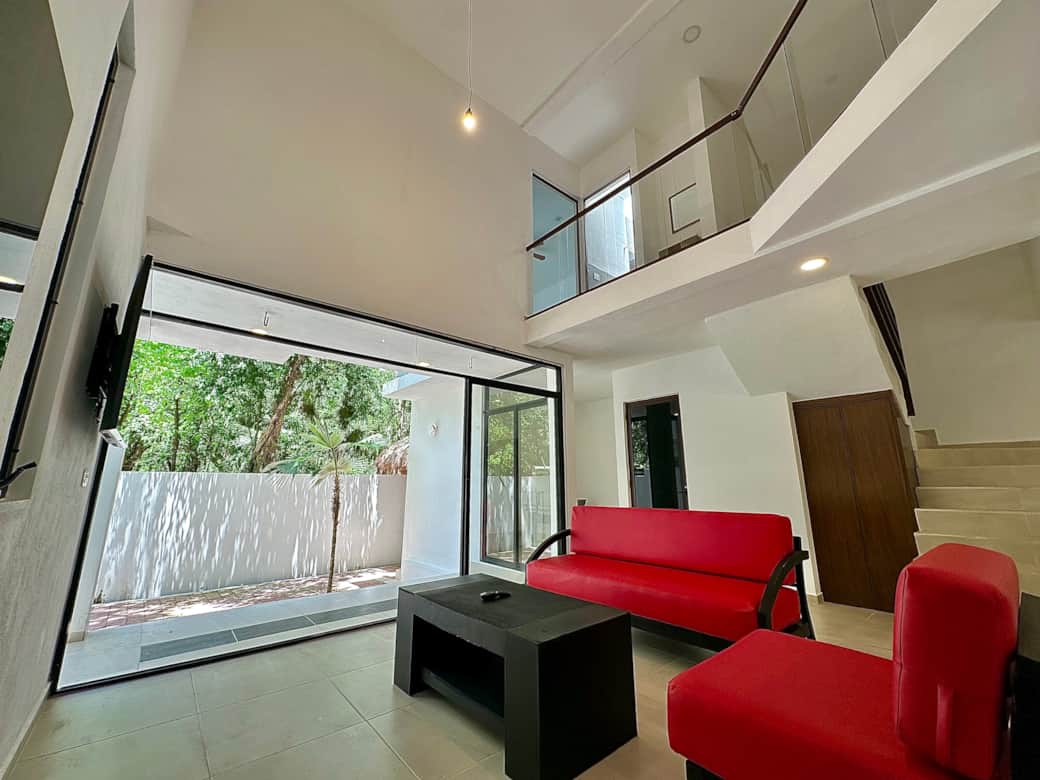 Open living space: living room, kitchen, dining area, patio