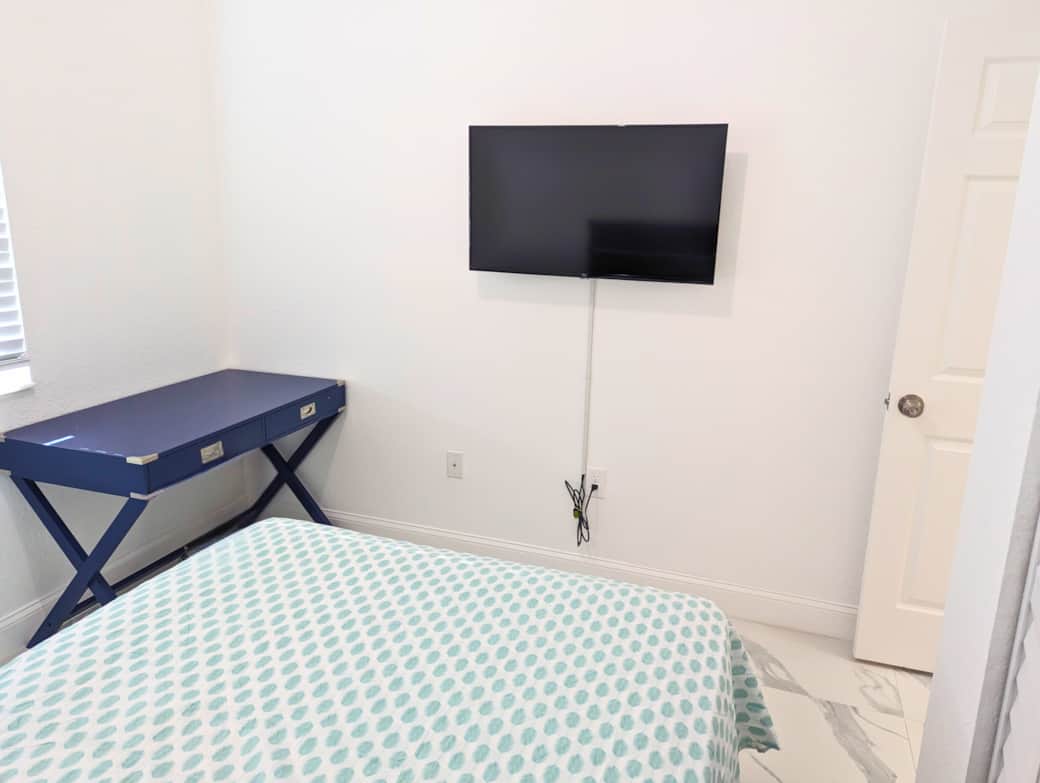 Bedroom 1 (Alt View) – Relax with TV and clean, modern furnishings.