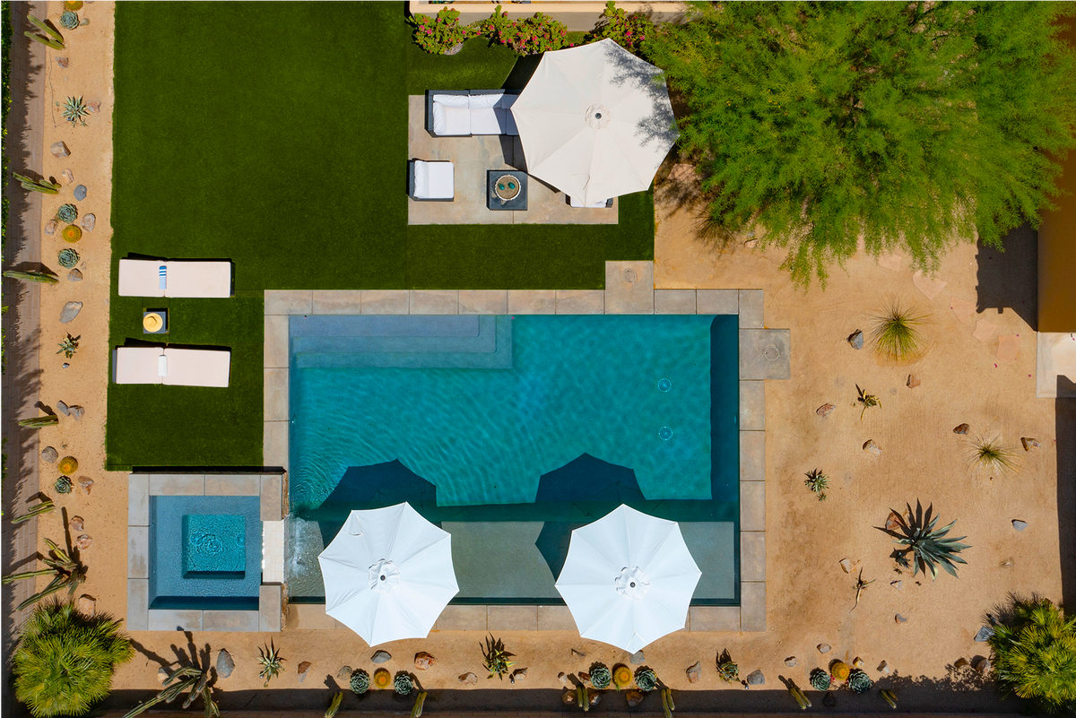Huge private backyard. Saltwater pool has a submerged suntan shelf running the entire length. Built in umbrellas help you stay cool in the shallow water while enjoying the sun.