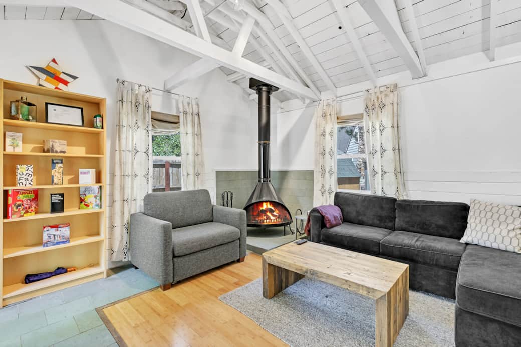Experience comfort in the sunlit cabin living room with a sofa bed, TV, and natural light. Experience comfort in the sunlit cabin living room with a sofa bed, TV, and natural light.