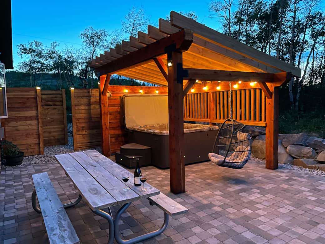 Enjoy a dinner on the patio or relax in the hanging egg chair next to the 6-person hot tub Enjoy a dinner on the patio or relax in the hanging egg chair next to the 6-person hot tub