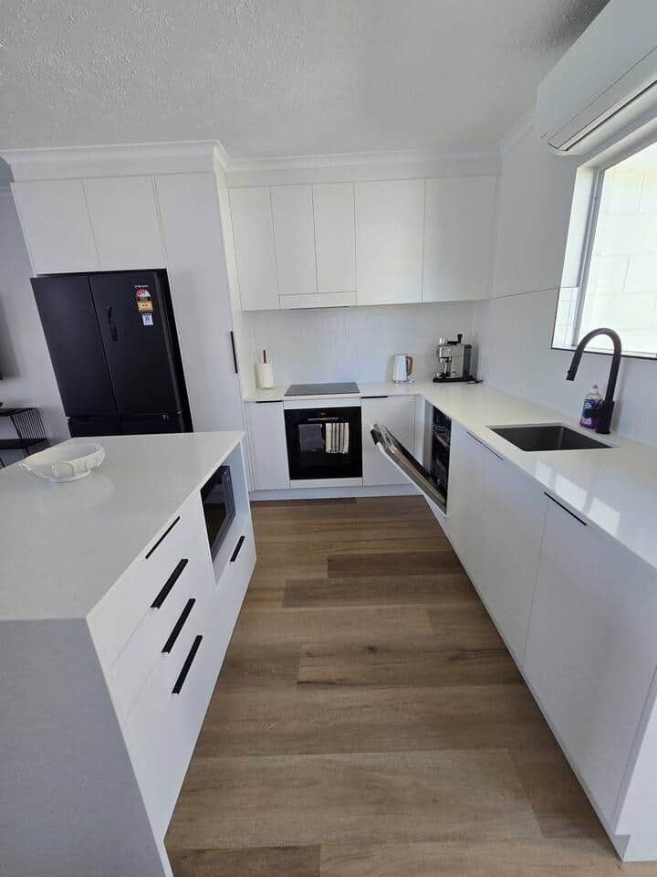 Kitchen has Oven, stovetop, microwave, coffee machine, full size fridge and dishwasher