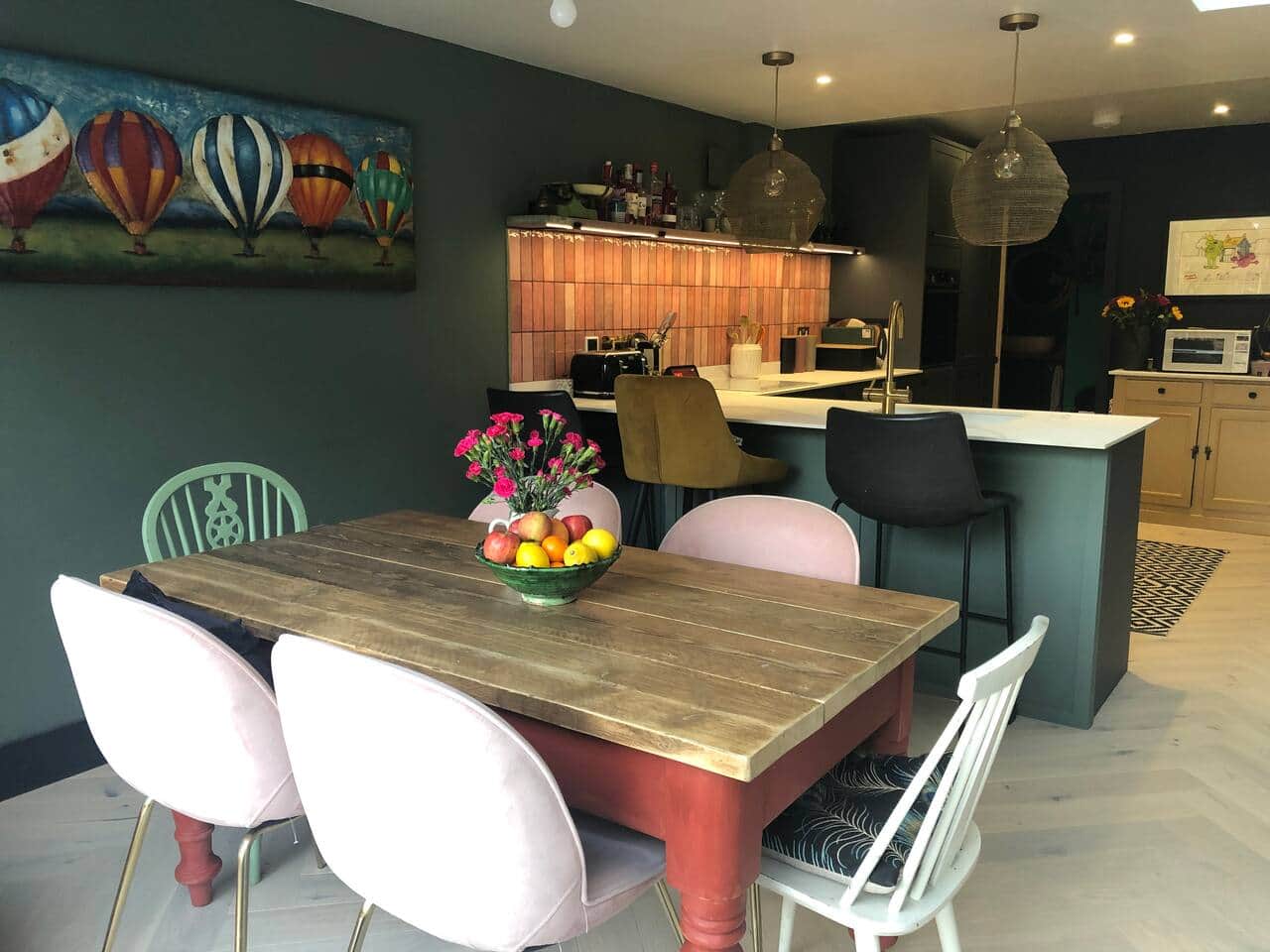 View from patio doors of dining table and large open plan kitchen. 