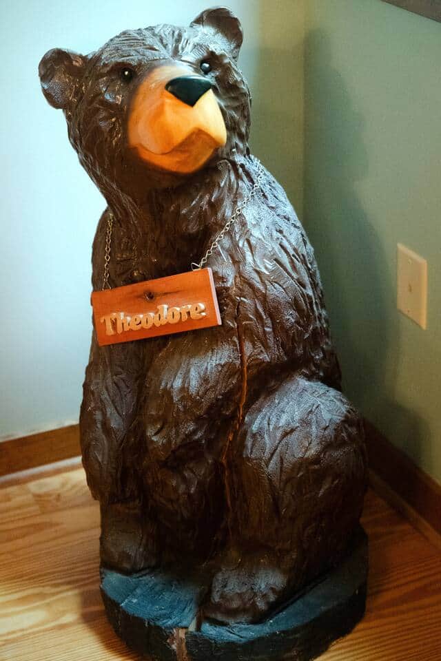 Meet Theodore — our resident wooden bear who greets every guest.