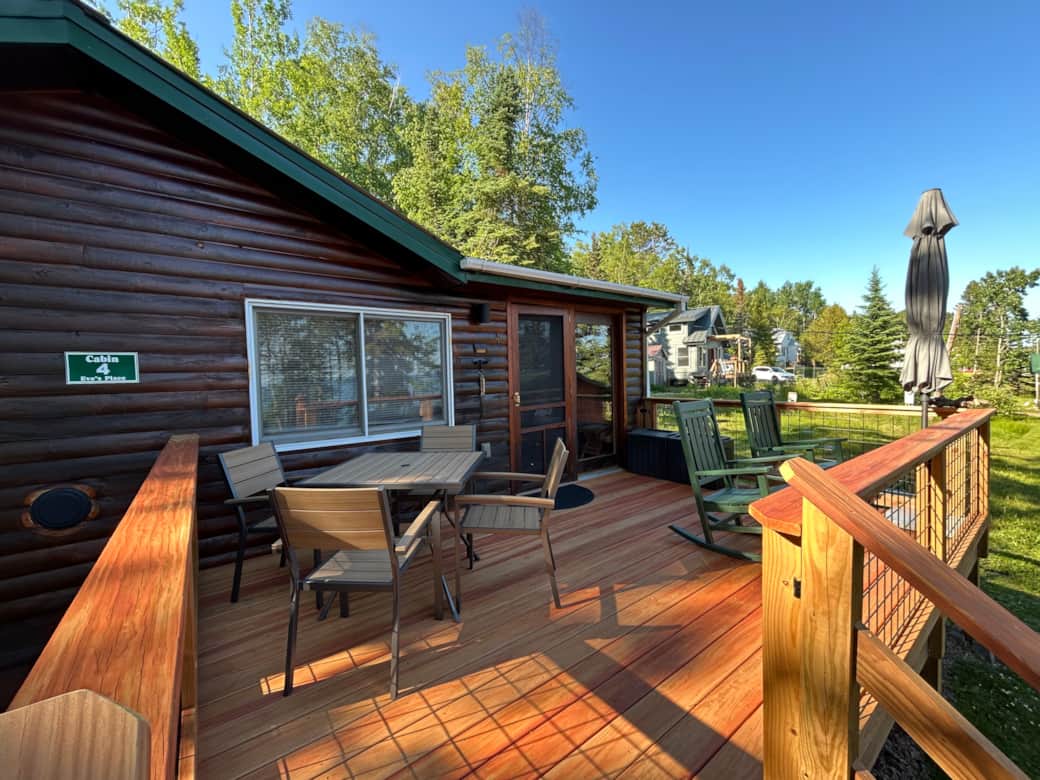 Cabin 4 deck update 2026. Two rocking chairs and a table for 4 for dining. Hidden dog gate on steps