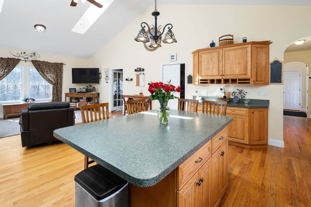 Open concept kitchen with seating and living room (one of three gathering places!)