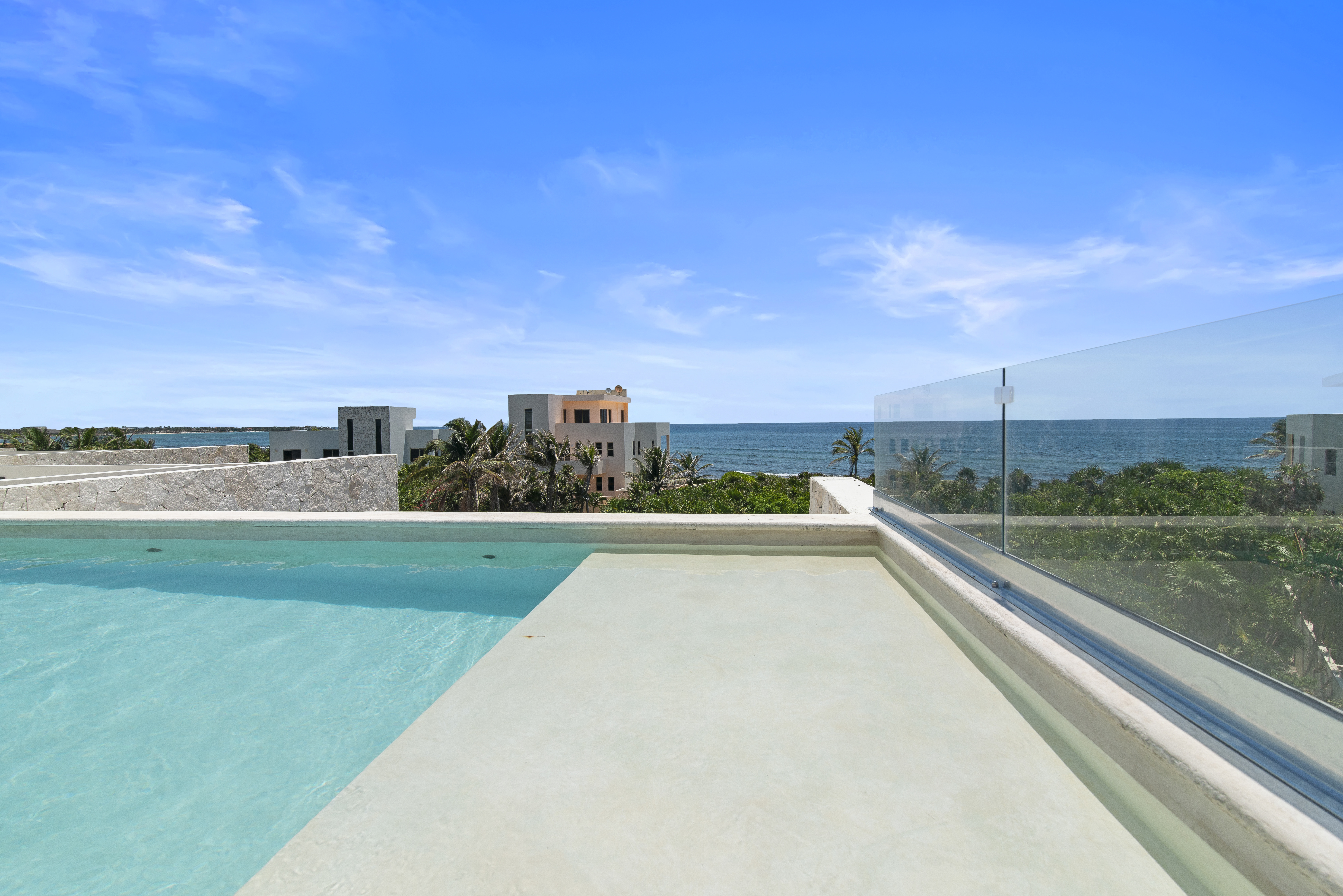 Rooftop pool with breathtaking Caribbean Sea views, perfect for relaxing and soaking up the sun.